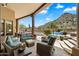 Covered patio with comfortable seating and a luxurious pool in the background at 7731 E Soaring Eagle Way, Scottsdale, AZ 85266