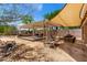 Backyard with pergola, outdoor seating, a fire pit, and shade sail at 82 N 221St Ave, Buckeye, AZ 85326
