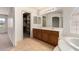 Bright bathroom with a soaking tub, glass shower, and double sink vanity at 82 N 221St Ave, Buckeye, AZ 85326