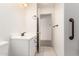 Bathroom featuring white vanity, tile floor, and open doorway to adjacent room at 82 N 221St Ave, Buckeye, AZ 85326