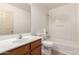 Clean bathroom features a single sink vanity and shower-tub combination at 82 N 221St Ave, Buckeye, AZ 85326