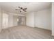 Spacious bedroom features a ceiling fan and neutral color palette at 82 N 221St Ave, Buckeye, AZ 85326