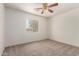 Bedroom with a large window allowing natural light and ceiling fan at 82 N 221St Ave, Buckeye, AZ 85326