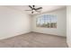 Bedroom with a large window allowing natural light and ceiling fan at 82 N 221St Ave, Buckeye, AZ 85326