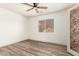 Bedroom with wood floors, ceiling fan, a window and view to the exterior at 82 N 221St Ave, Buckeye, AZ 85326