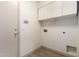Laundry room with white cabinets, hook ups for washer and dryer, and wood style floors at 82 N 221St Ave, Buckeye, AZ 85326