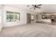 Inviting living room with a big window and ceiling fan overlooking the backyard at 82 N 221St Ave, Buckeye, AZ 85326