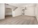Bright, open-concept living room with neutral carpet and elegant chandelier at 82 N 221St Ave, Buckeye, AZ 85326