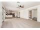 Open living space with carpet, ceiling fan and access to the kitchen at 82 N 221St Ave, Buckeye, AZ 85326