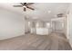Spacious loft area with neutral carpet and walls providing an adaptable space in the home at 82 N 221St Ave, Buckeye, AZ 85326