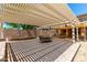 Inviting outdoor patio with a shaded pergola, perfect for entertaining or relaxing in a private backyard setting at 82 N 221St Ave, Buckeye, AZ 85326