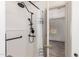 Shower featuring bronze fixtures, shower curtain, and access to an adjacent bedroom at 82 N 221St Ave, Buckeye, AZ 85326