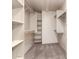 Walk-in closet features built-in shelving and ample storage space at 82 N 221St Ave, Buckeye, AZ 85326