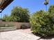 Backyard patio with block wall, mature trees and outdoor bench at 8355 E Via De Encanto --, Scottsdale, AZ 85258