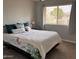 Bedroom showcasing natural light, soft decor, and a comfortable queen bed with a floral comforter at 8355 E Via De Encanto --, Scottsdale, AZ 85258