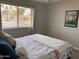 Bedroom showcasing natural light, soft decor, and a comfortable queen bed with a floral comforter at 8355 E Via De Encanto --, Scottsdale, AZ 85258