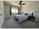 Carpeted bedroom with a ceiling fan, window, and two bedside lamps at 8355 E Via De Encanto --, Scottsdale, AZ 85258