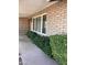 Inviting front porch with brick accents, mature landscaping, and a charming wooden door at 8355 E Via De Encanto --, Scottsdale, AZ 85258