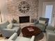 Cozy living room featuring stone fireplace, comfortable seating, and views to the backyard at 8355 E Via De Encanto --, Scottsdale, AZ 85258