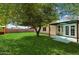 Green backyard with large trees providing ample shade, near a cozy outdoor seating area at 8540 W Ocotillo Rd, Glendale, AZ 85305