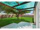 Spacious backyard featuring green lawn, mature trees, and a covered patio area at 8540 W Ocotillo Rd, Glendale, AZ 85305