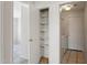 Hallway with storage closet, laundry area, and tile flooring at 8540 W Ocotillo Rd, Glendale, AZ 85305
