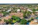 Community aerial view featuring red-tiled roofs, mature trees, a pool, tennis courts, and well-maintained streets at 8653 E Royal Palm Rd # 1030, Scottsdale, AZ 85258