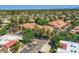 Expansive aerial view of a community with tree-lined streets and Southwestern-style architecture and red tile roofs at 8653 E Royal Palm Rd # 1030, Scottsdale, AZ 85258