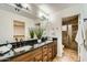 This bathroom features double sinks and granite countertops and opens to a shower at 8653 E Royal Palm Rd # 1030, Scottsdale, AZ 85258