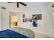 This bedroom features custom art and a ceiling fan, along with a comfortable bed at 8653 E Royal Palm Rd # 1030, Scottsdale, AZ 85258