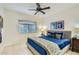 This bedroom features a ceiling fan and a window with blinds, along with a comfortable bed at 8653 E Royal Palm Rd # 1030, Scottsdale, AZ 85258