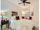 This bedroom features a ceiling fan and seating, along with a comfortable bed at 8653 E Royal Palm Rd # 1030, Scottsdale, AZ 85258