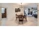 This dining area features wood floors and table with 4 chairs with an eye catching light fixture and access to the living room at 8653 E Royal Palm Rd # 1030, Scottsdale, AZ 85258