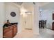 Warm entryway with light wood floors, a dark granite counter, and neutral tones at 8653 E Royal Palm Rd # 1030, Scottsdale, AZ 85258