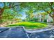 Well-manicured community lawn and lush landscaping bordering the parking area, showcasing the property's beautiful surroundings at 8653 E Royal Palm Rd # 1030, Scottsdale, AZ 85258
