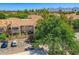 Beautiful building exterior with a red tile roof, mature landscaping, and parking, set against a mountain backdrop at 8653 E Royal Palm Rd # 1030, Scottsdale, AZ 85258
