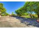 Exterior view of a parking lot near beautiful trees and landscaping, offering convenient parking for residents and visitors at 8653 E Royal Palm Rd # 1030, Scottsdale, AZ 85258