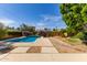 Inviting backyard features a sparkling pool, mature landscaping, and patio area at 8738 E Vista Dr, Scottsdale, AZ 85250