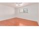 Bright bedroom with hardwood floors, ceiling fan, and shuttered windows bringing in natural light at 8738 E Vista Dr, Scottsdale, AZ 85250
