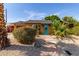 Charming home featuring desert landscaping with a bright turquoise front door and stone walkway at 8738 E Vista Dr, Scottsdale, AZ 85250
