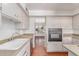 Well-lit kitchen with stainless steel appliances, white cabinets, and a functional layout at 8738 E Vista Dr, Scottsdale, AZ 85250