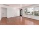 Light-filled living area featuring hardwood floors, neutral walls, and door with decorative glass at 8738 E Vista Dr, Scottsdale, AZ 85250