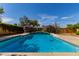 A refreshing blue pool is surrounded by vibrant greenery, creating a tranquil outdoor oasis at 8738 E Vista Dr, Scottsdale, AZ 85250