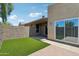 View of backyard with synthetic lawn, concrete patio and privacy fence at 921 S Hacienda Dr, Tempe, AZ 85281