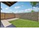 Enclosed backyard featuring well-maintained artificial grass and privacy wall at 921 S Hacienda Dr, Tempe, AZ 85281
