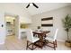 Cozy dining area featuring a modern table set and adjacent updated kitchen with white cabinetry at 921 S Hacienda Dr, Tempe, AZ 85281
