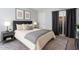 Well-staged main bedroom boasts a king bed and neutral tones at 921 S Hacienda Dr, Tempe, AZ 85281