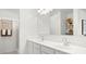 Contemporary bathroom with a double sink vanity, large mirror, and neutral color palette, plus a walk-in shower at 10622 W Bloch Rd, Tolleson, AZ 85353