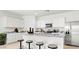Bright kitchen featuring white cabinetry, stainless steel appliances, and a gray granite countertop island with barstool seating at 10622 W Bloch Rd, Tolleson, AZ 85353