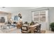 Inviting living space featuring a dining table, a comfortable couch, and ample natural light from large windows at 10622 W Bloch Rd, Tolleson, AZ 85353
